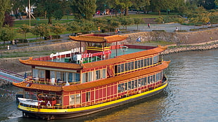brown, black, and yellow passenger boat