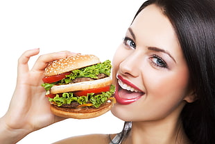 photo of woman holding burger