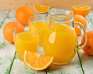 orange juice on clear glass pitcher