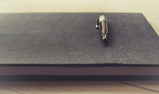 black and gray slick pen on black jouranl book HD wallpaper