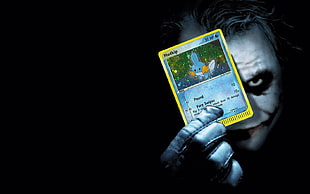 The Joker holding Pokemon trading card