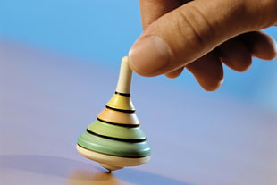 person holding a Spin-top