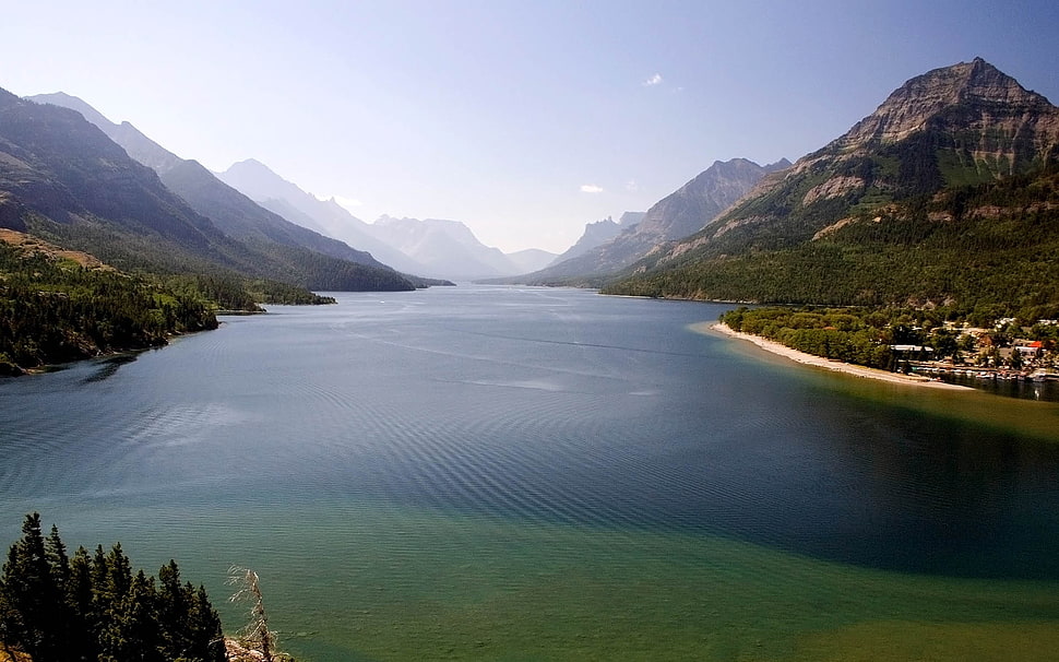 lake between mountains during day time HD wallpaper