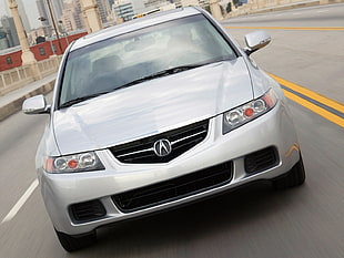silver Acura TL on road at daytime