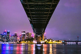 city under the bridge view during nighttime, harbour bridge