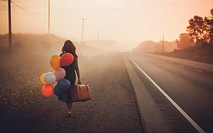 woman holding bag and balloon