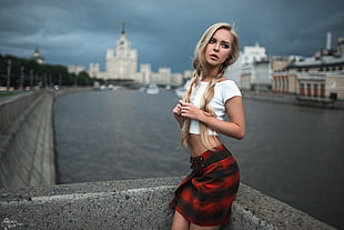 woman wearing white crew-neck t-shirt and red plaid mini skirt