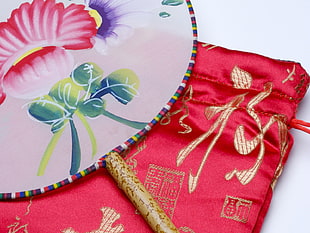 white, green, and pink floral hand fan