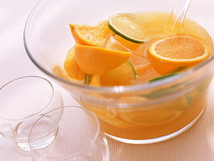 clear highball glass with slice orange fruits on white background
