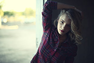 woman in maroon, black, and grey plaid sports shirt