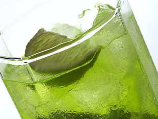 green liquid filled drinking glass