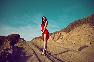 woman wearing red dress under blue sky during daytime