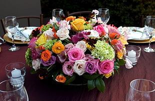 pink, white, and orange petaled flower arrangement on center of table