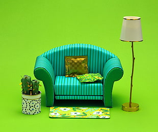 green leather sofa beside white floor lamp