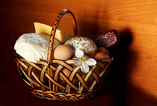 organic eggs and doughnuts on brown woven basket