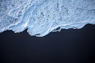 high angle photography of beach with waves touching shore