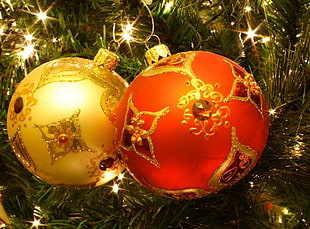 two gold and red Christmas baubles