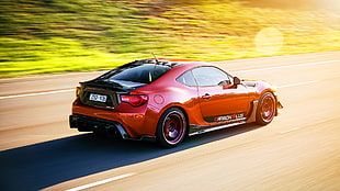 red Toyota GT86 on concrete road at daytime