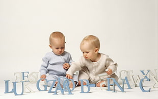 two baby near white and blue free standing letters