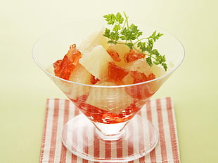 fruits in clear glass with green garnish