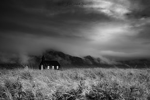 grayscale photo of chapel surrounded by grass field, icelandic