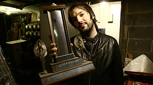 man holding trophy