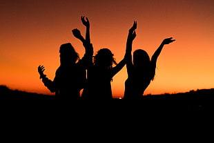 silhouette photo of three women raising their hands HD wallpaper