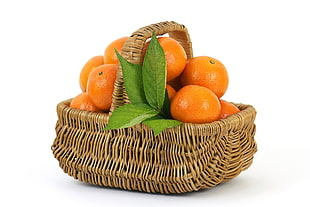 bundle of oranges on brown wicker basket HD wallpaper