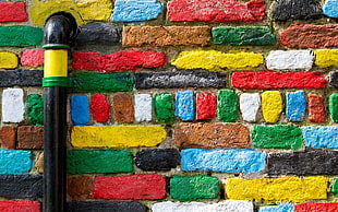red, blue, and green area rug, bricks, texture, wall, colorful