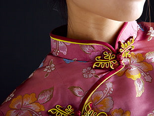 person wearing pink floral collared top
