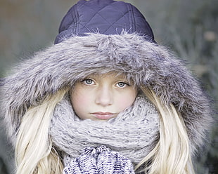 selective focus photography of girl wearing blue coat and white scarf