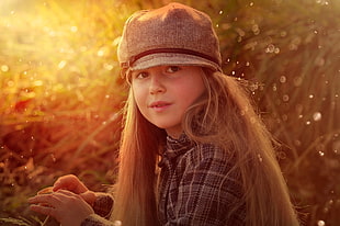 girl in gray hat near green grass