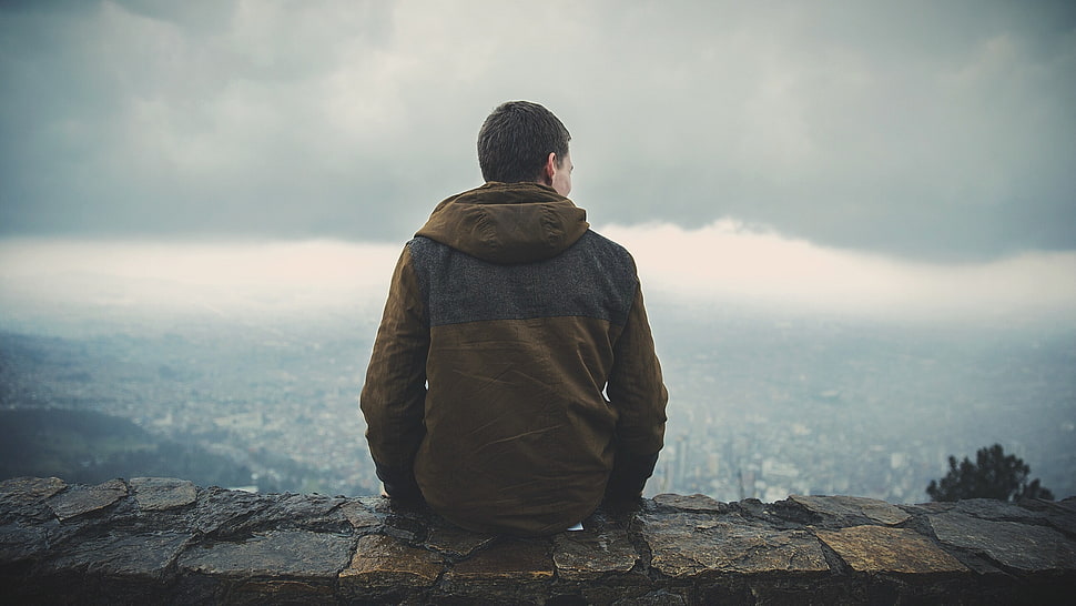 man wearing brown jacket under white sky during daytime HD wallpaper