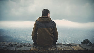 man wearing brown jacket under white sky during daytime