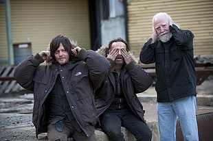 three men wearing jacket doing the hear no evil, see no evil, and hear no evil gesture