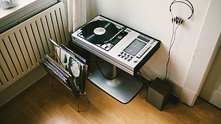 white and black electric sewing machine, headphones, turntables