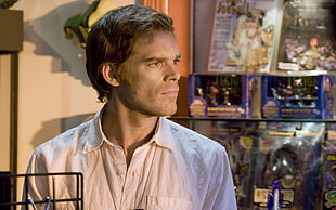 man wearing white collared shirt in a store of toys