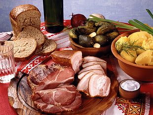 slices of grilled meat and wheat bread beside bowl of mashed potato