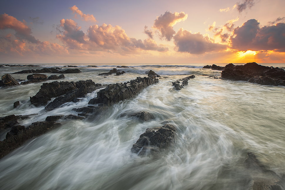Pink Cloudy Sunset over Rocky Ocean HD wallpaper