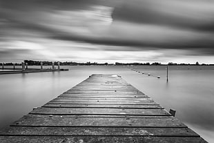 grayscale photo of wood dock