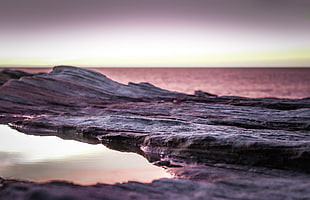 landscape photography of gray rock formation near body of water