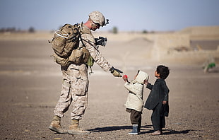 Soldier giving food to kids HD wallpaper