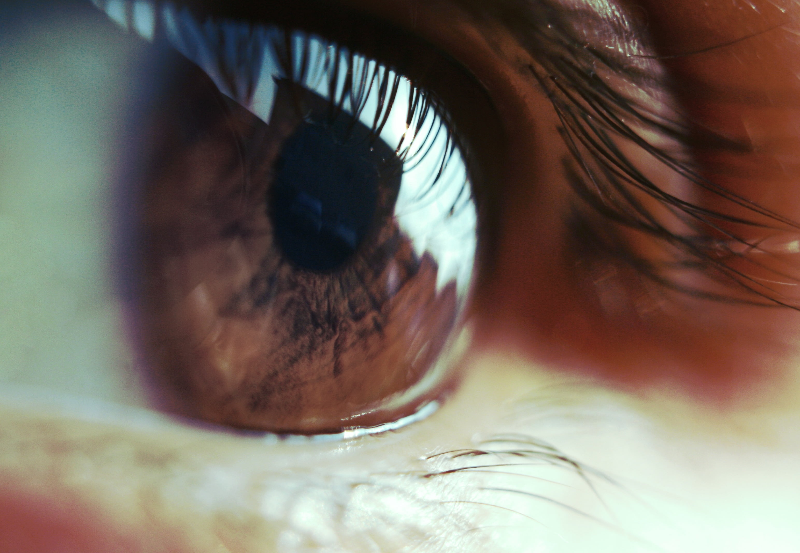 selective focus photography of human eye