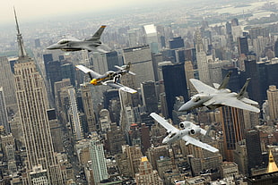 aerial photography of fighting jets on metropolitan HD wallpaper
