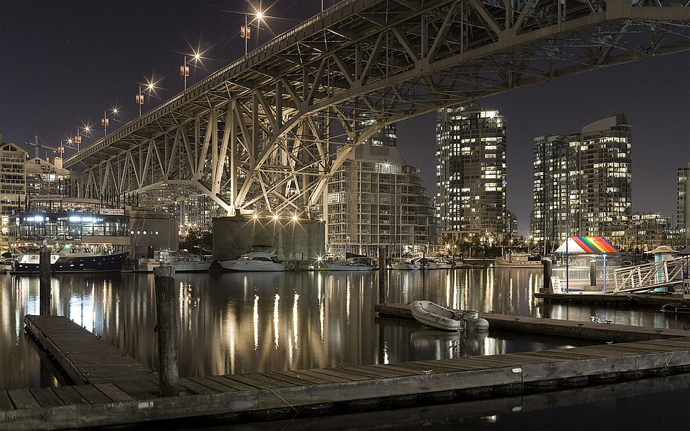 gray concrete city building, cityscape, bridge, boat, night HD wallpaper