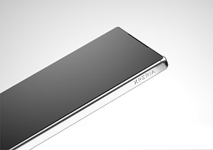 black and silver Sony Xperia smartphone on white surface
