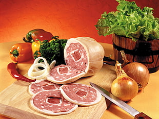 sliced ham on brown wooden chopping board