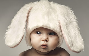 baby's white rabbit-themed aviator hat, baby, face