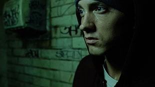 Eminem leaning on wall