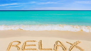 white sand beach with relax sand writing under blue white sky during daytime
